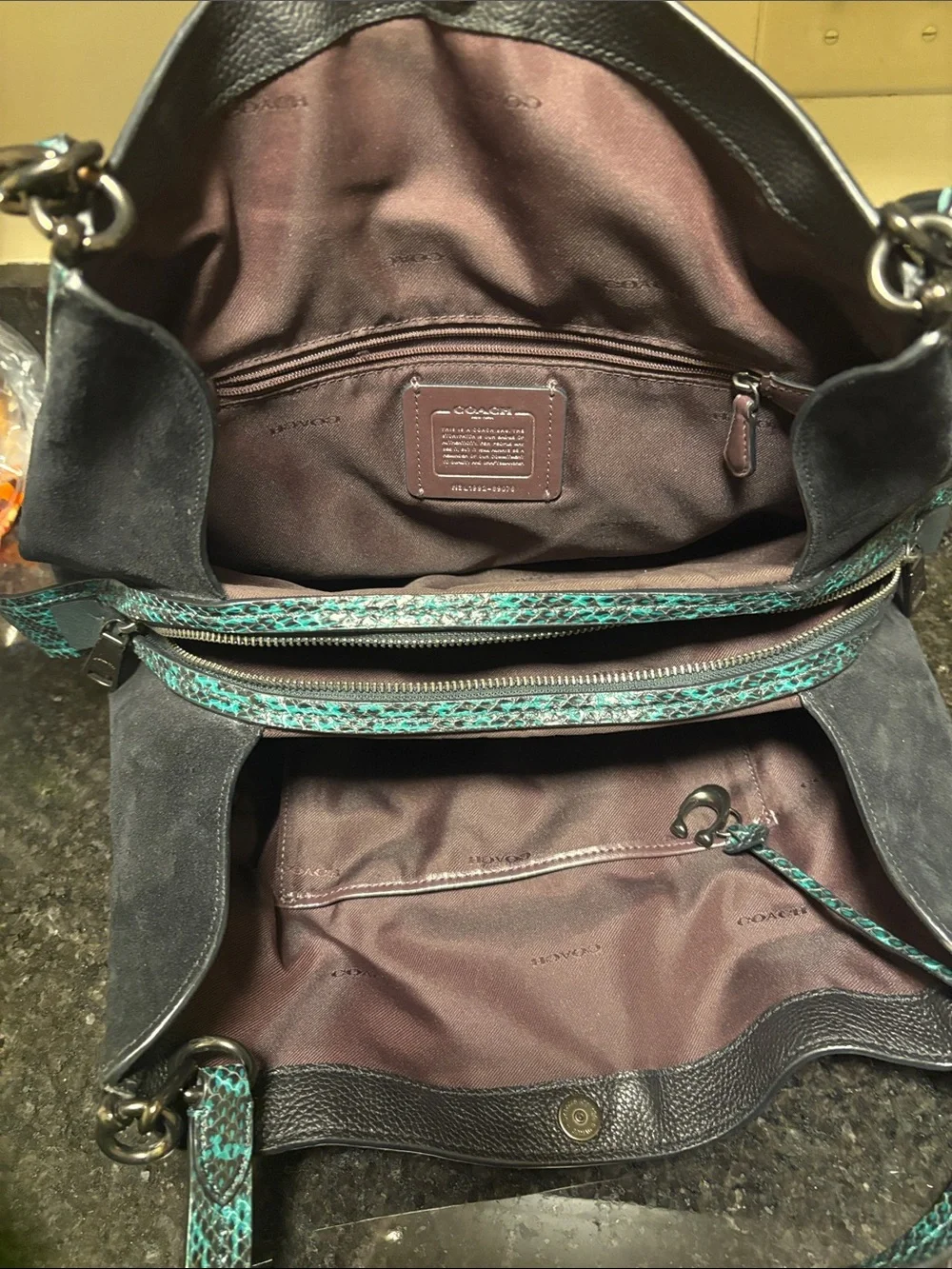 Black Leather Coach Dalton 31 with teal green snake print trim